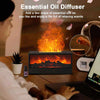 Essential oil diffuser with a fireplace design on a table, surrounded by a person using a laptop.