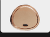 Rose gold circular object with USB port on a white background