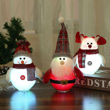 LED Christmas decorations featuring illuminated Santa Claus, snowman, and reindeer ornaments with festive scarves and hats.