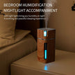 Ultrasonic air humidifier with USB mini mist maker and soft LED night light on bedside table