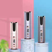 Three electronic devices on cylindrical platforms with a pink and blue background