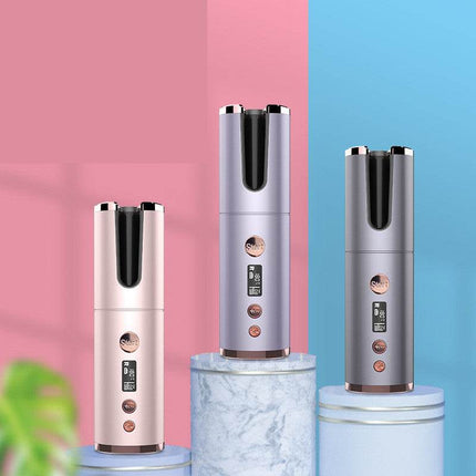 Three electronic devices on cylindrical platforms with a pink and blue background